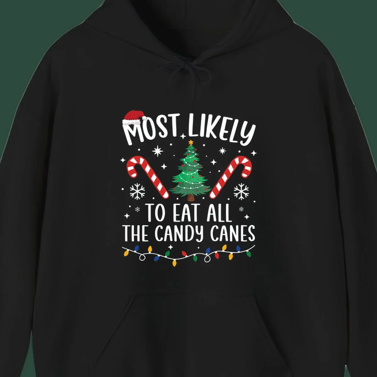 Most likely to eat all candy canes Christmas design with text, tree, candy canes, and lights.