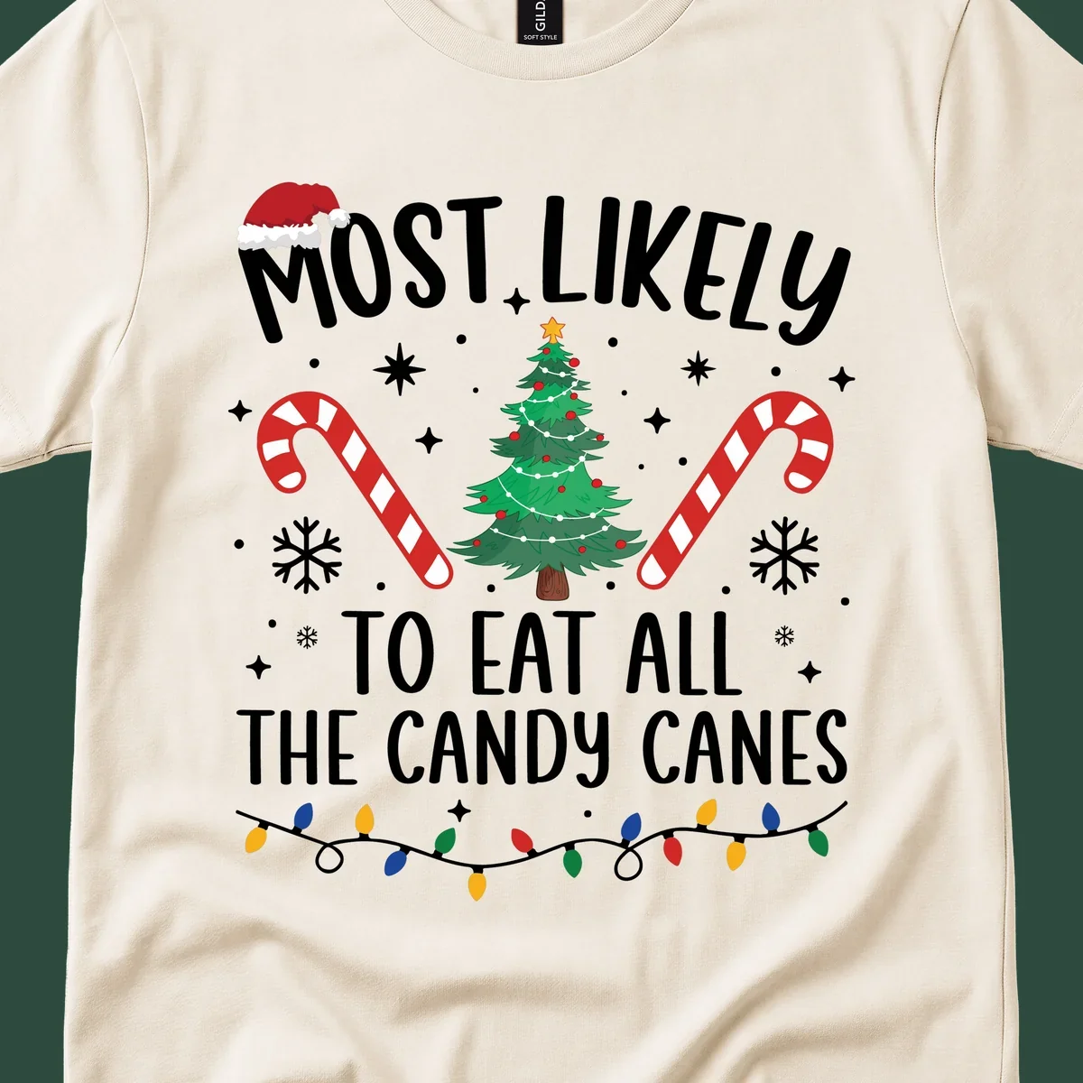 Most likely to eat all candy canes Christmas design with text, tree, candy canes, and lights.