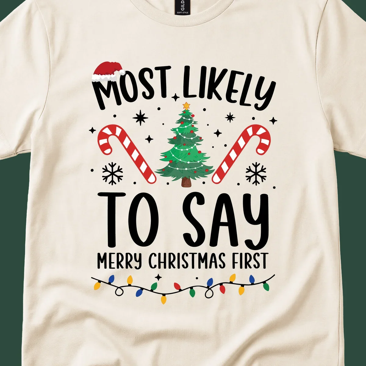 Most Likely To Say Merry Christmas First text with Christmas tree, candy canes, and Santa hat. Merry Christmas First keyword.