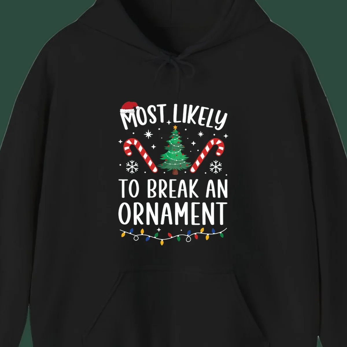 Most likely to break ornament Christmas graphic with text, tree, candy canes, and Santa hat.