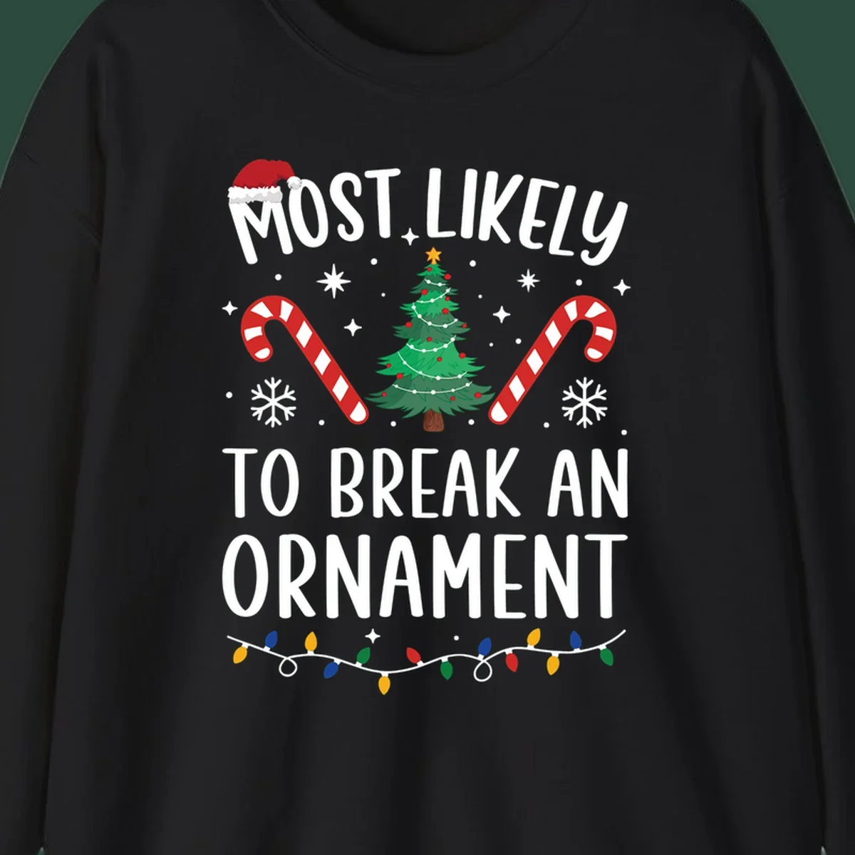 Most likely to break ornament Christmas graphic with text, tree, candy canes, and Santa hat.