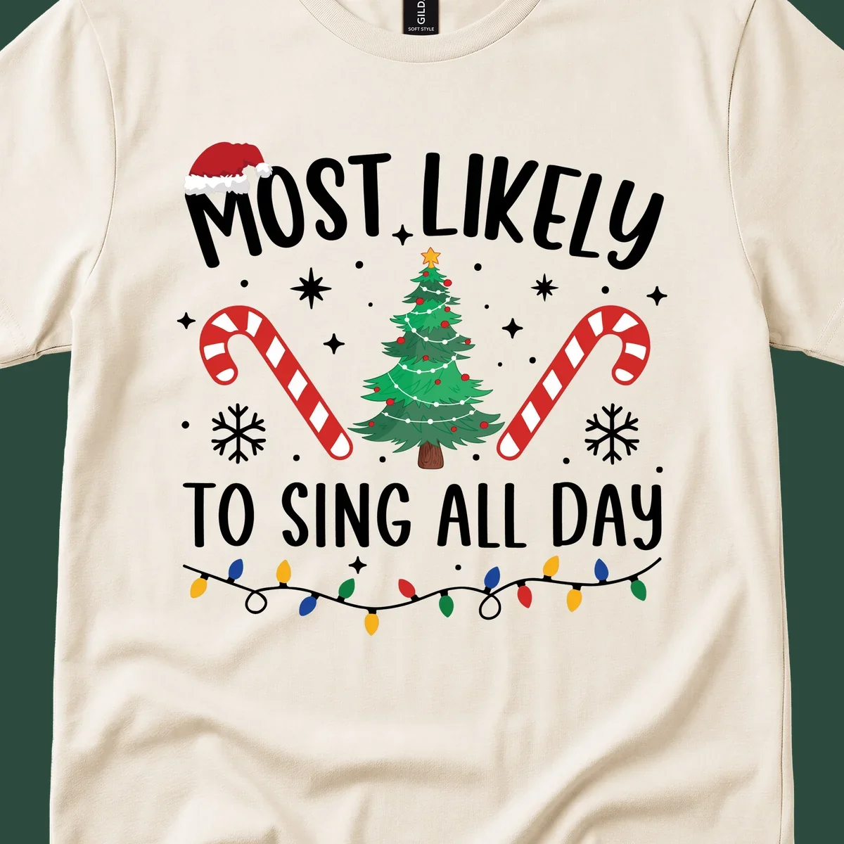 Most Likely To Sing All Day Christmas text with festive holiday graphics like a tree, candy canes, and lights.