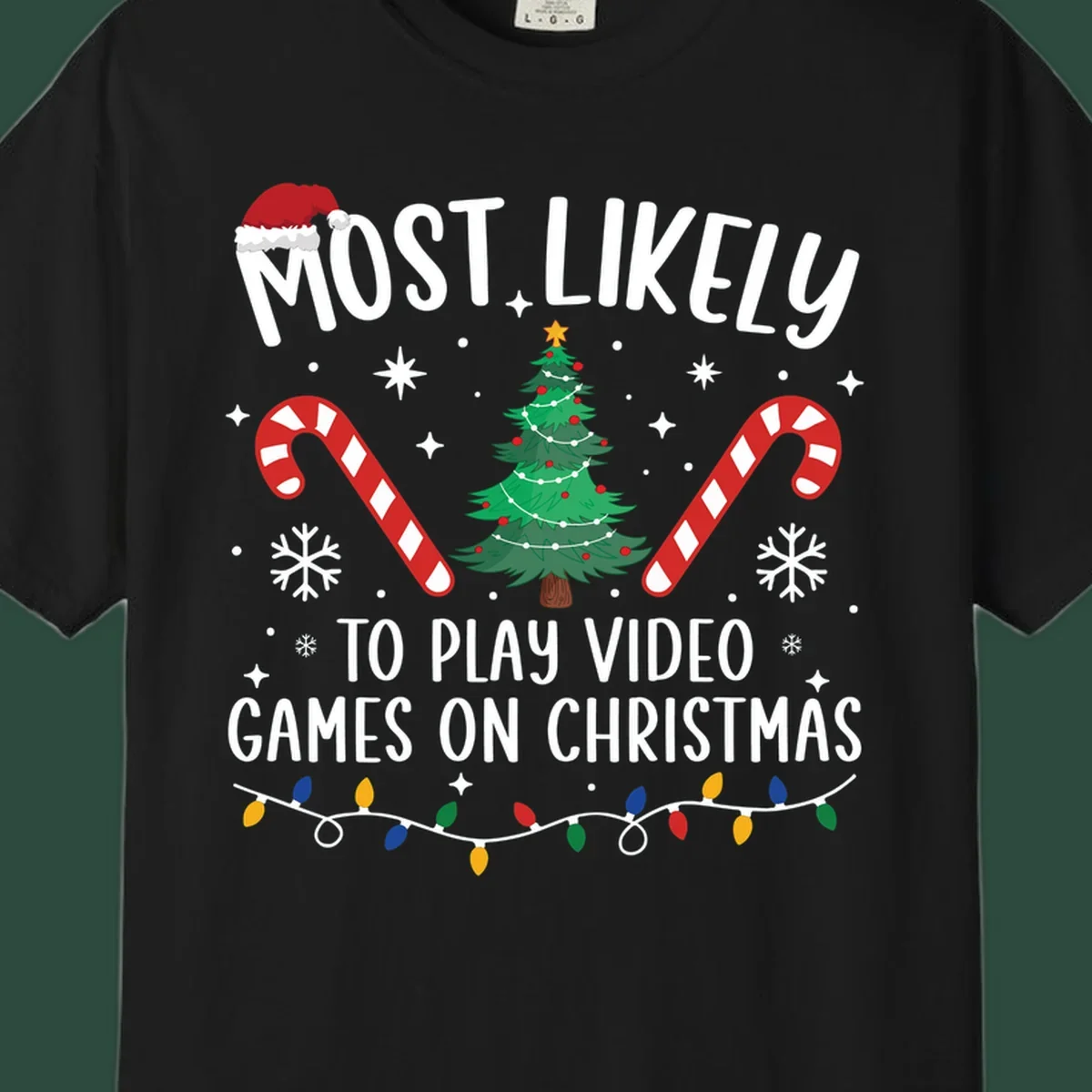 Most Likely To Play Video Games On Christmas design with text, Christmas tree, candy canes, and lights.