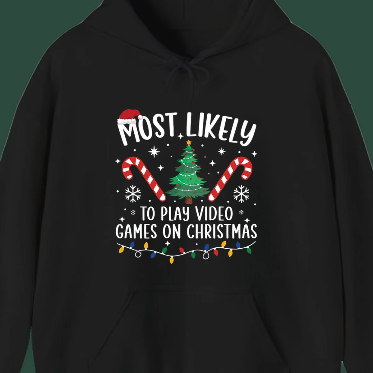 Most Likely To Play Video Games On Christmas design with text, Christmas tree, candy canes, and lights.
