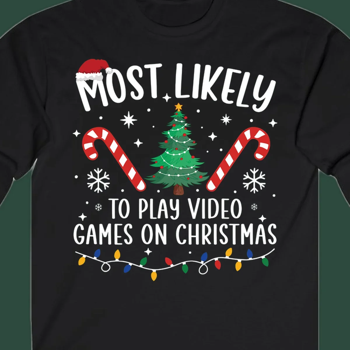 Most Likely To Play Video Games On Christmas design with text, Christmas tree, candy canes, and lights.