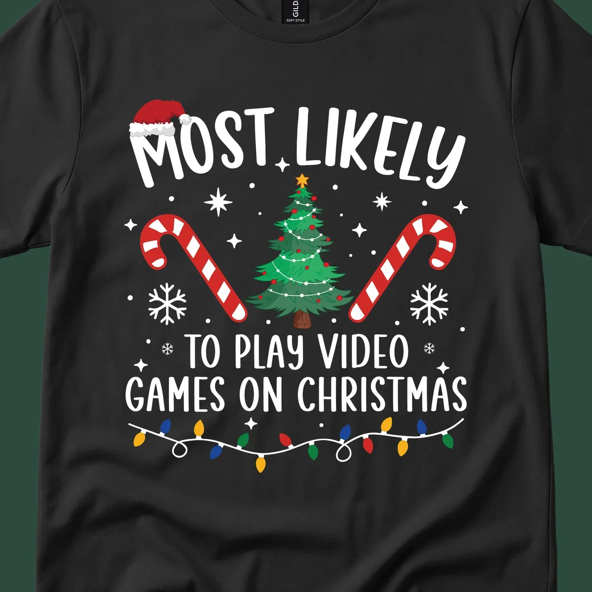 Most Likely To Play Video Games On Christmas design with text, Christmas tree, candy canes, and lights.