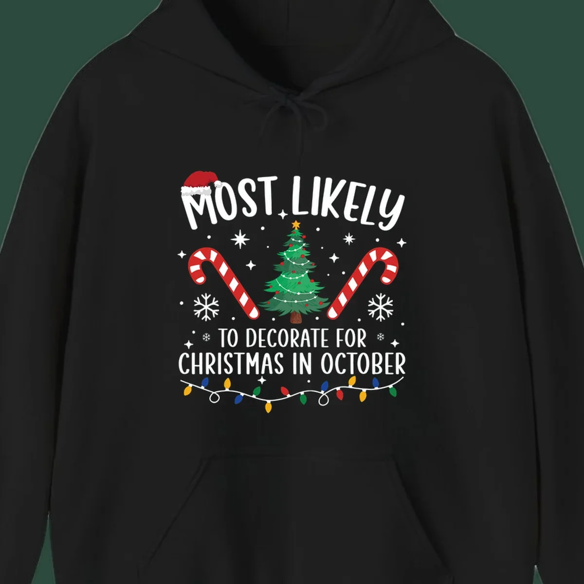 Most Likely To Decorate For Christmas In October text with Christmas tree, candy canes, and Santa hat.