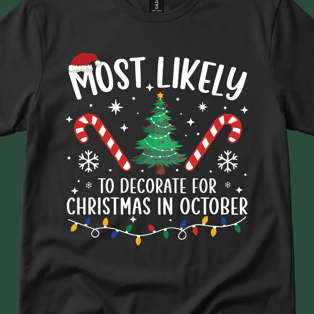 Most Likely To Decorate For Christmas In October text with Christmas tree, candy canes, and Santa hat.