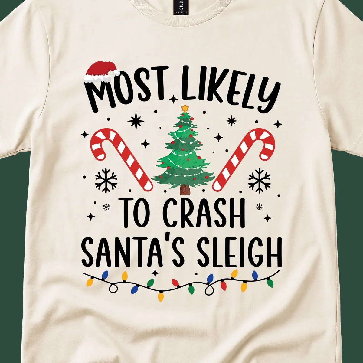 Most Likely To Crash Santa's Sleigh holiday design with Santa hat, Christmas tree, candy canes, and lights.