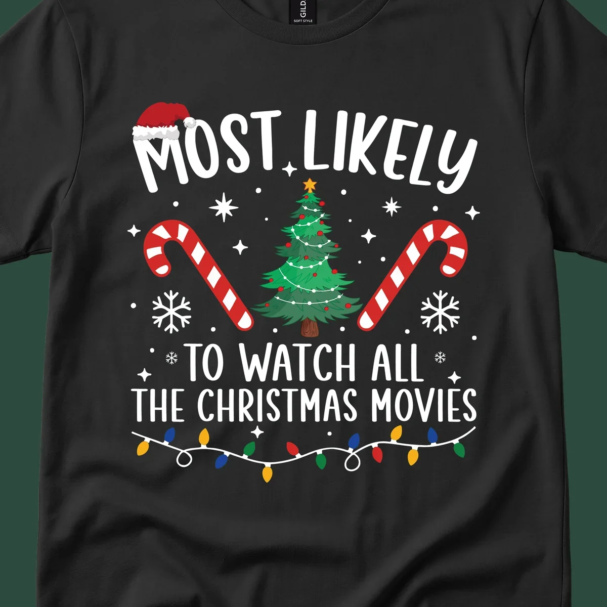 Most Likely To Watch All The Christmas Movies text with christmas tree, candy canes, and lights.