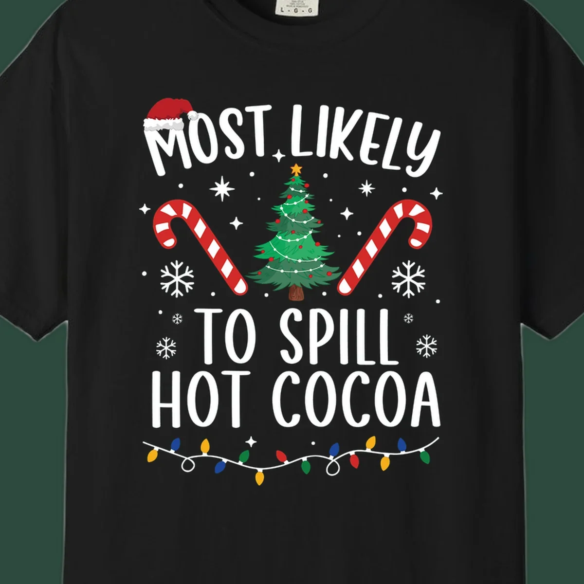 Most Likely To Spill Hot Cocoa Christmas design with text, tree, candy canes, and lights.