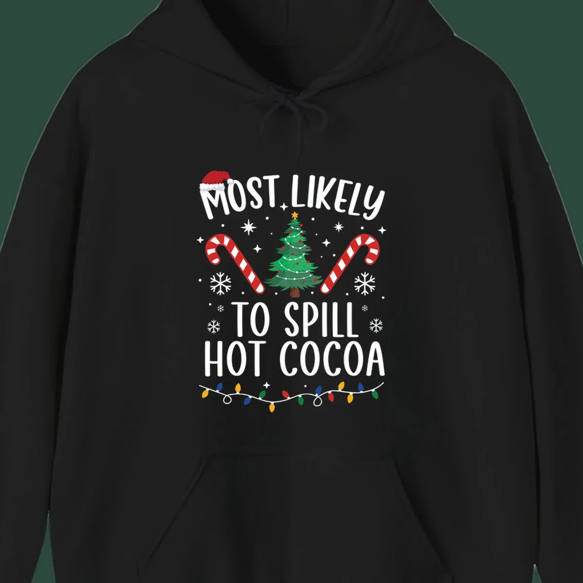 Most Likely To Spill Hot Cocoa Christmas design with text, tree, candy canes, and lights.