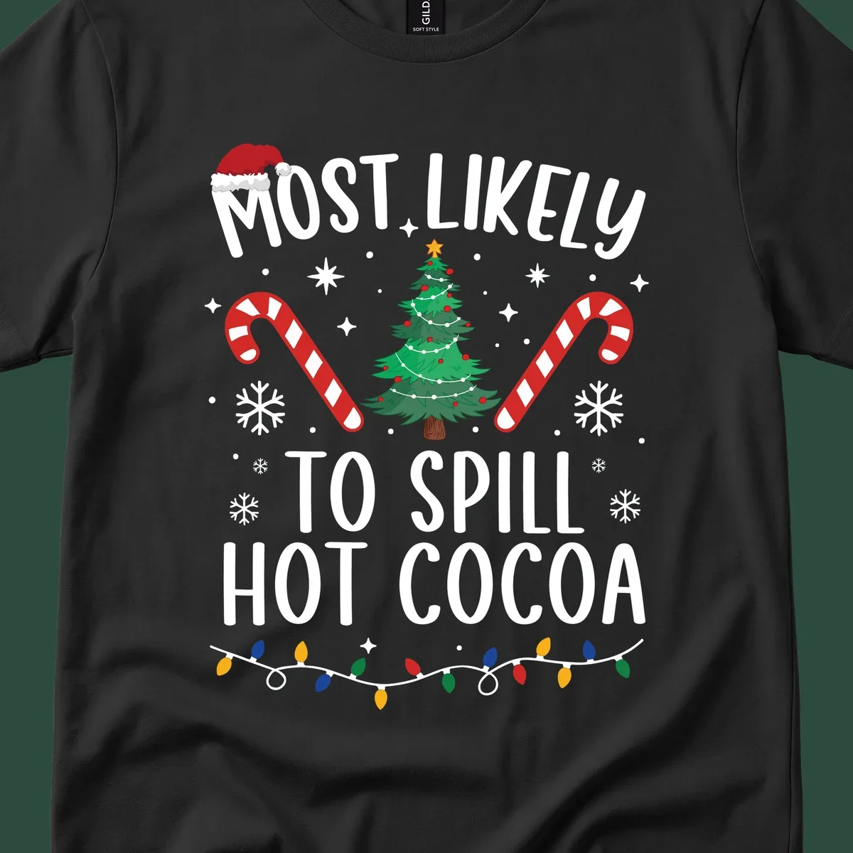 Most Likely To Spill Hot Cocoa Christmas design with text, tree, candy canes, and lights.
