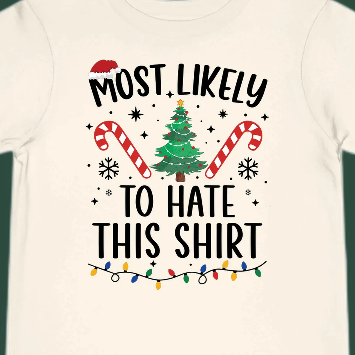 Text 'Most Likely To Hate This Shirt' with Christmas graphics like a tree, candy canes, and Santa hat.