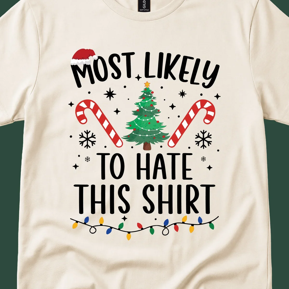 Text 'Most Likely To Hate This Shirt' with Christmas graphics like a tree, candy canes, and Santa hat.