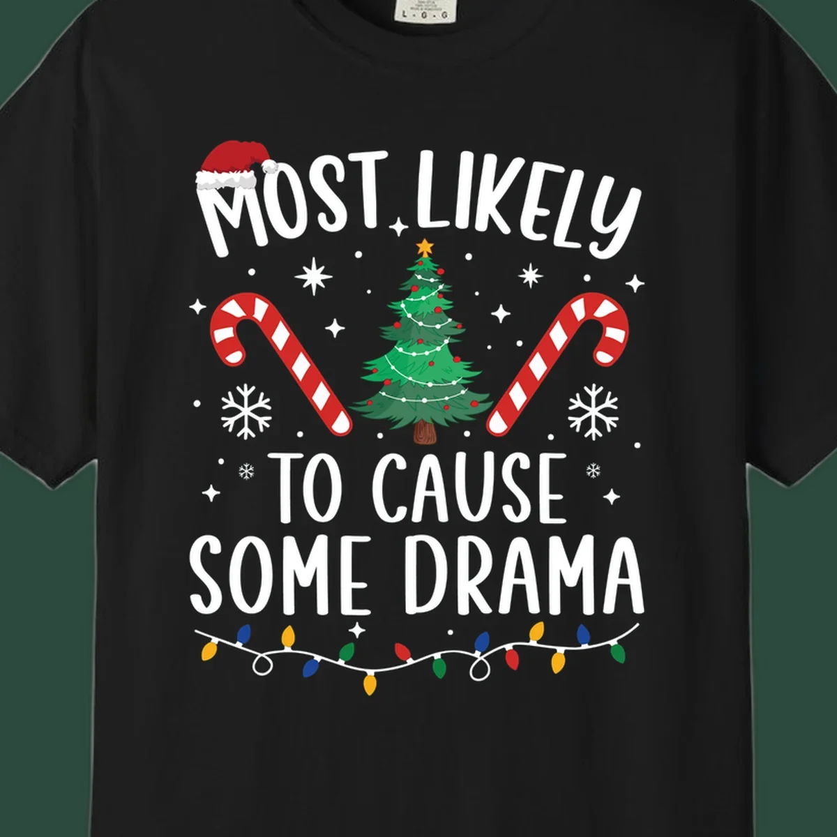 Most Likely To Cause Some Drama Christmas text with tree and decorations. Christmas crew shirt.