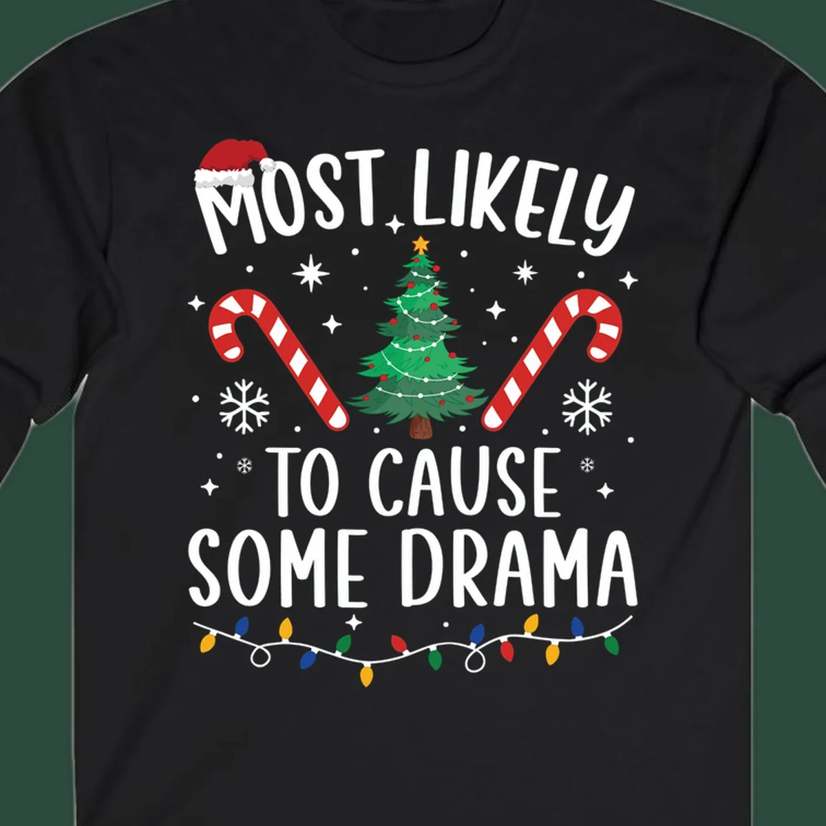 Most Likely To Cause Some Drama Christmas text with tree and decorations. Christmas crew shirt.