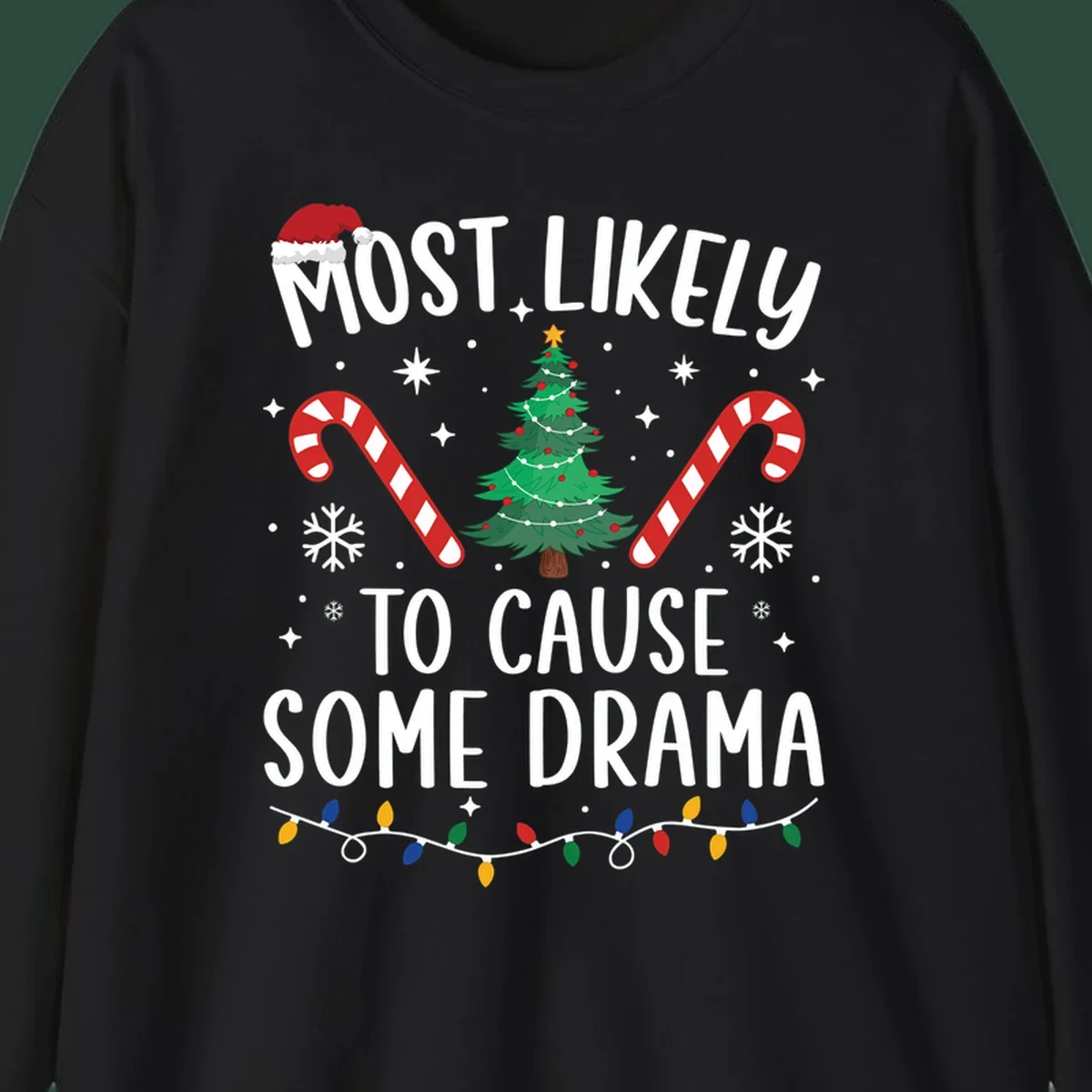 Most Likely To Cause Some Drama Christmas text with tree and decorations. Christmas crew shirt.