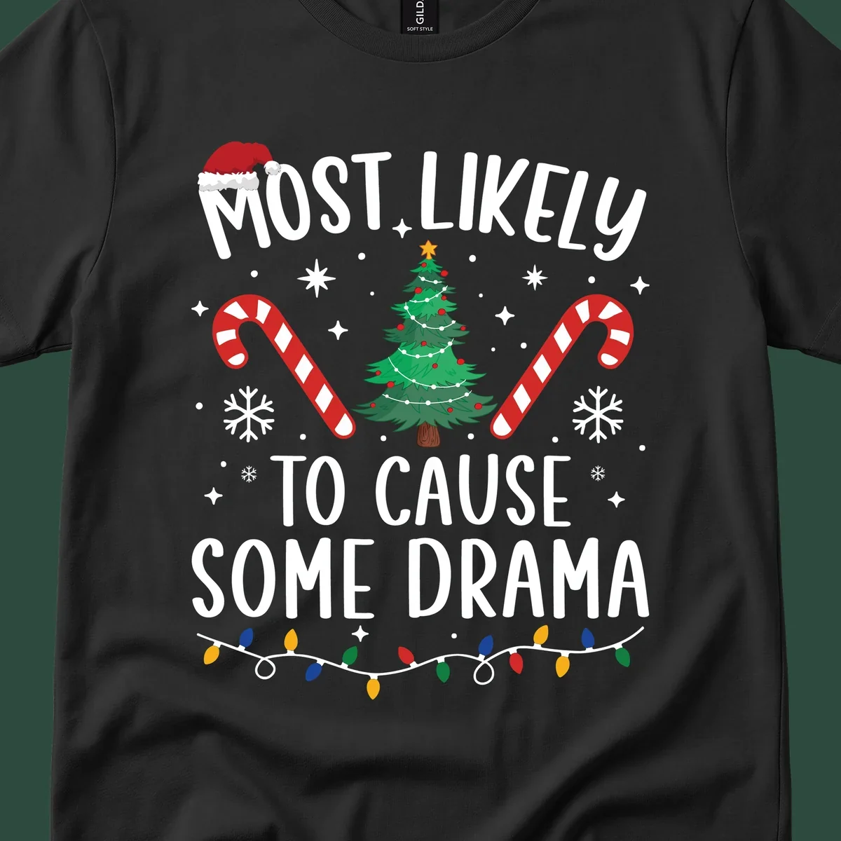 Most Likely To Cause Some Drama Christmas text with tree and decorations. Christmas crew shirt.