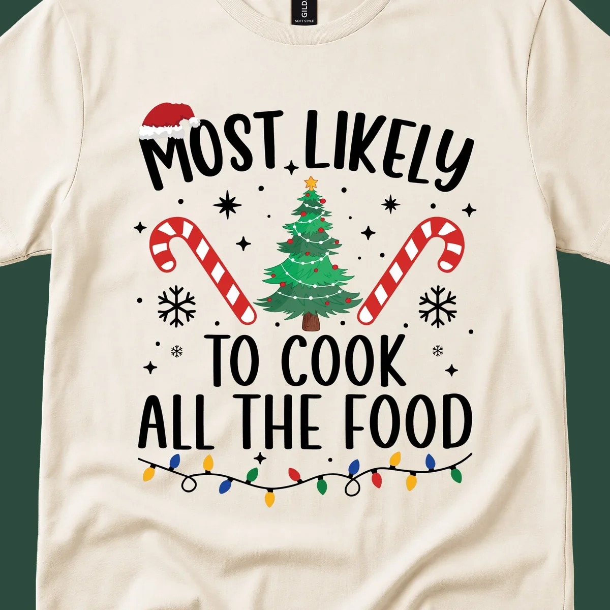 Most Likely To Cook All The Food Christmas design with Santa hat, tree, candy canes, and lights.