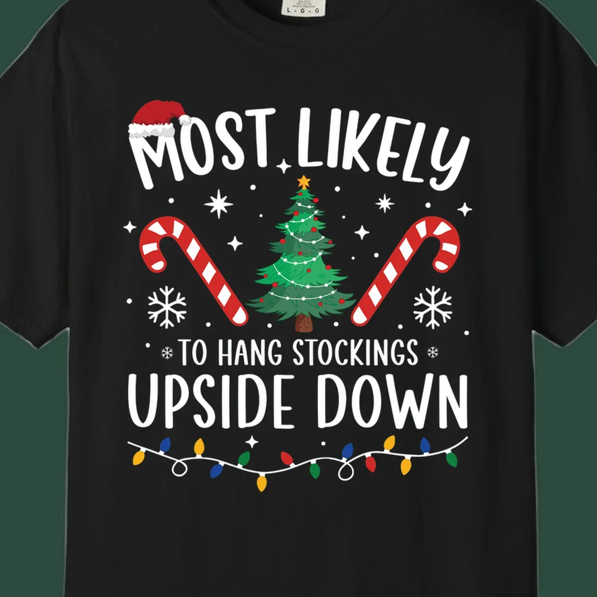 Most Likely To Hang Stockings Upside Down Christmas graphic with tree, candy canes, and Santa hat.