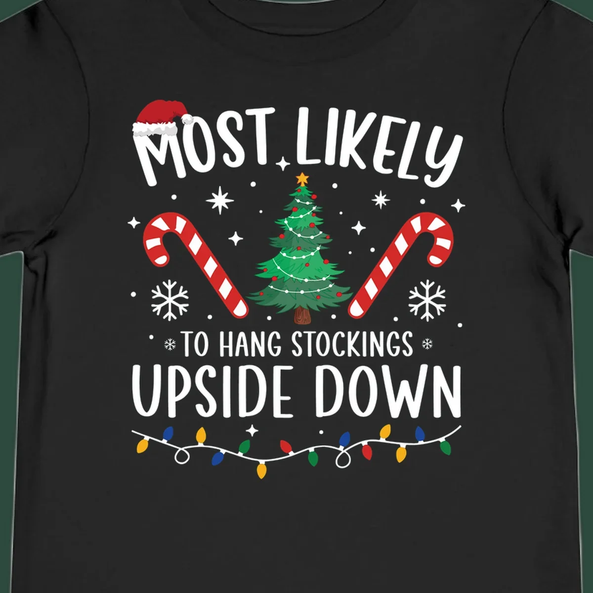 Most Likely To Hang Stockings Upside Down Christmas graphic with tree, candy canes, and Santa hat.