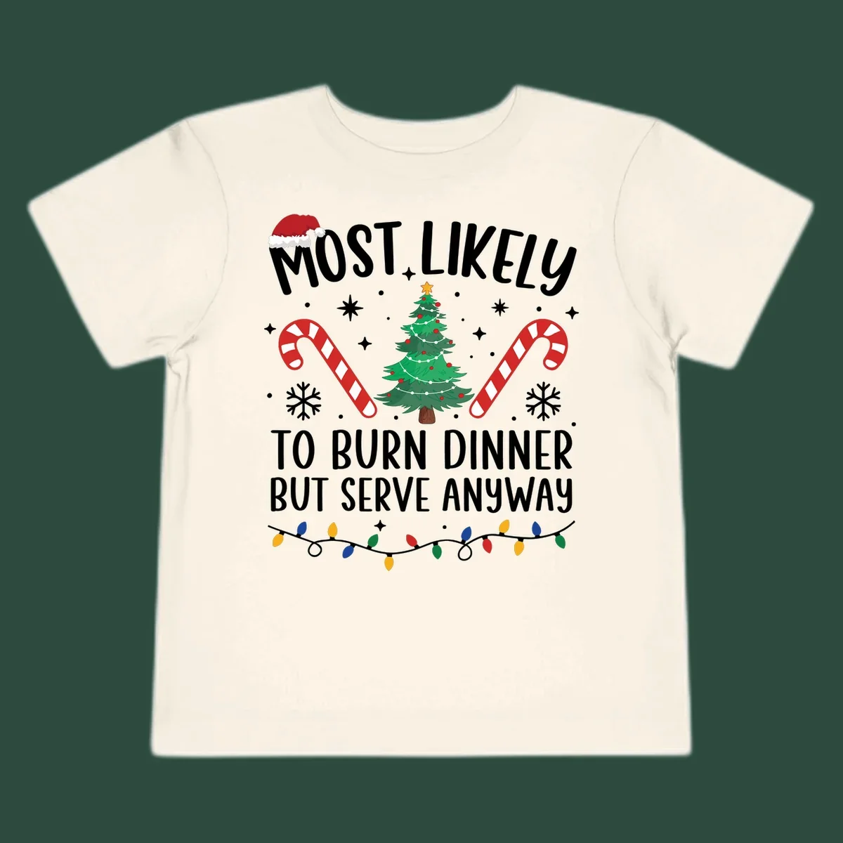 Most likely to burn dinner but serve anyway funny Christmas text with Santa hat, Christmas tree, and candy canes.