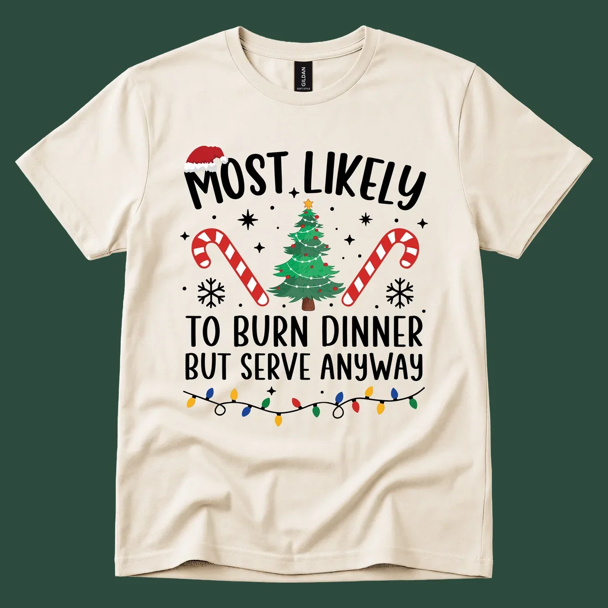 Most likely to burn dinner but serve anyway funny Christmas text with Santa hat, Christmas tree, and candy canes.