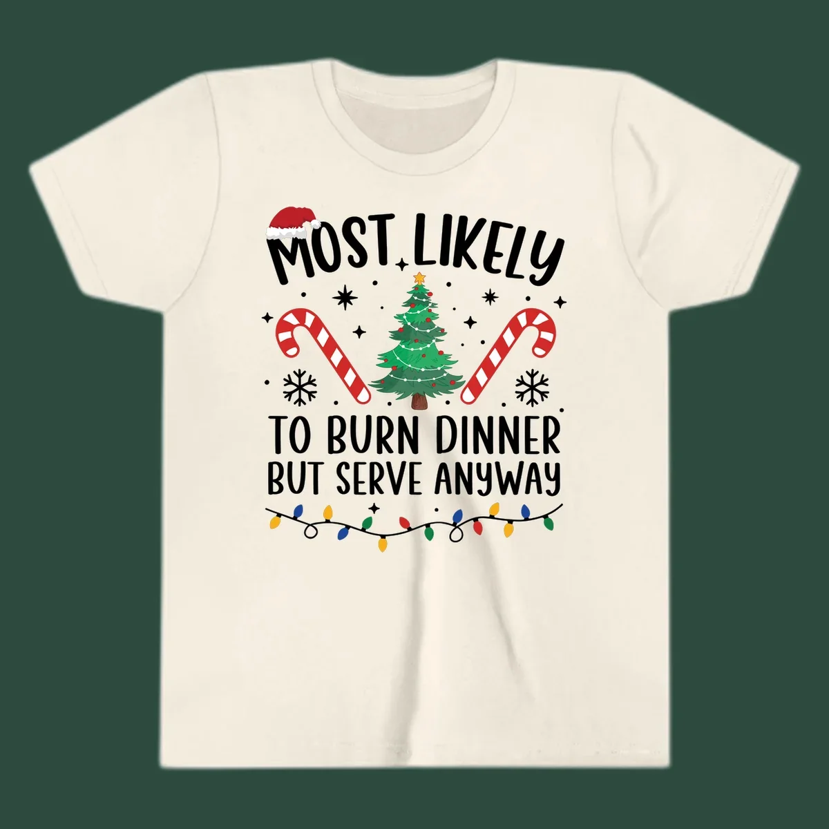 Most likely to burn dinner but serve anyway funny Christmas text with Santa hat, Christmas tree, and candy canes.