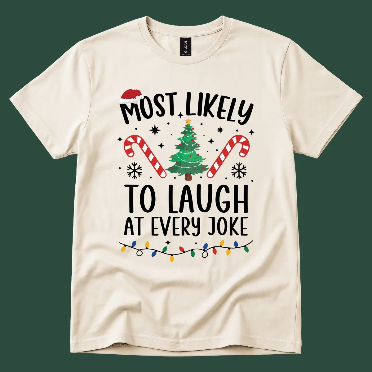 Most Likely To Laugh At Every Joke Christmas text with Santa hat, tree, candy canes, and lights.