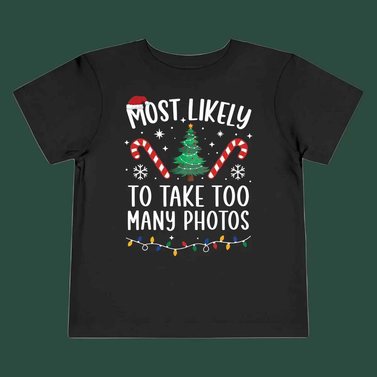 Most Likely To Take Too Many Photos Christmas design with text, candy canes, Christmas tree, and Santa hat.