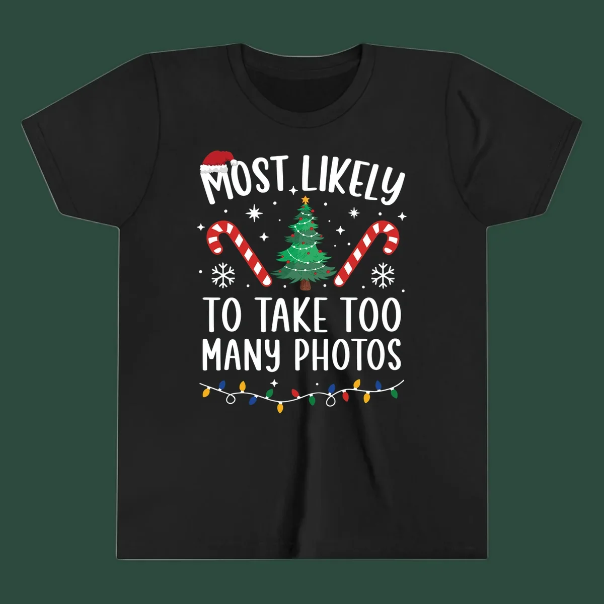 Most Likely To Take Too Many Photos Christmas design with text, candy canes, Christmas tree, and Santa hat.