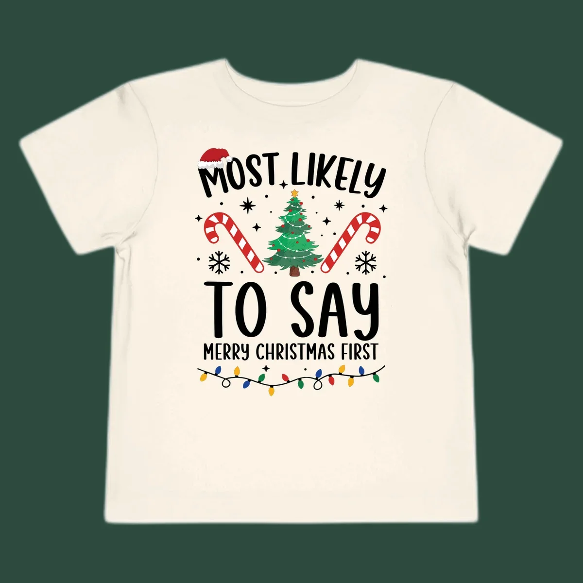 Most Likely To Say Merry Christmas First text with Christmas tree, candy canes, and Santa hat. Merry Christmas First keyword.