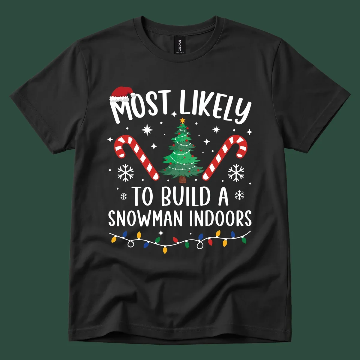 Most Likely To Build A Snowman Indoors text with Christmas graphics, including a tree and candy canes.