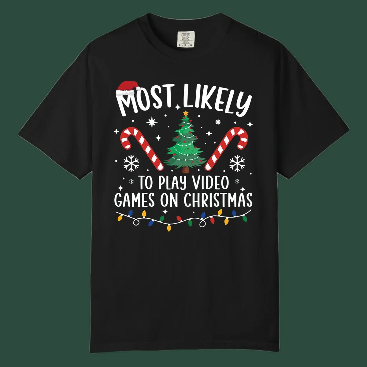 Most Likely To Play Video Games On Christmas design with text, Christmas tree, candy canes, and lights.