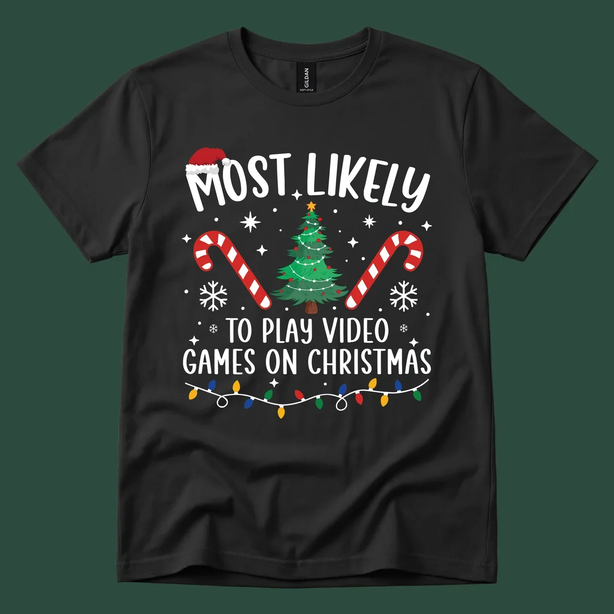 Most Likely To Play Video Games On Christmas design with text, Christmas tree, candy canes, and lights.