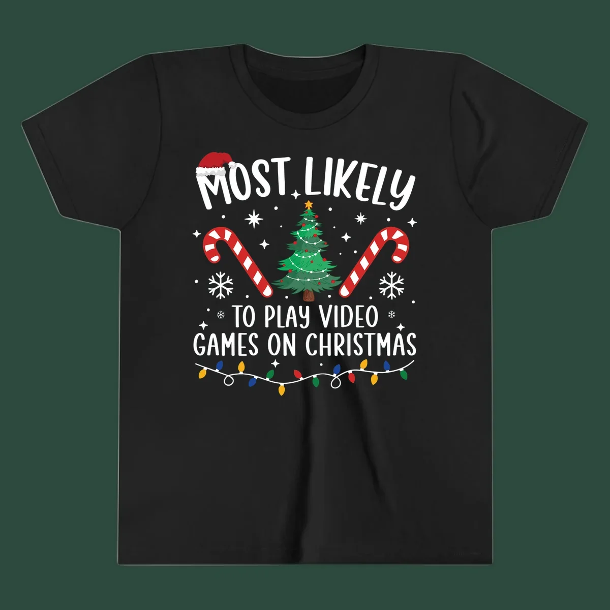 Most Likely To Play Video Games On Christmas design with text, Christmas tree, candy canes, and lights.