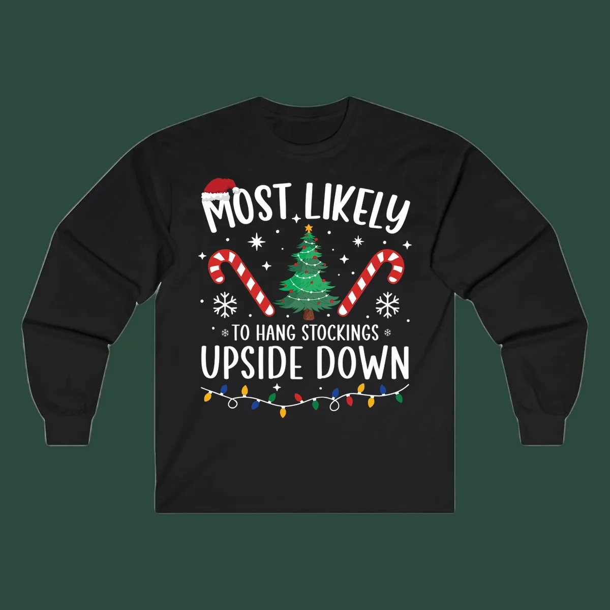 Most Likely To Hang Stockings Upside Down Christmas graphic with tree, candy canes, and Santa hat.