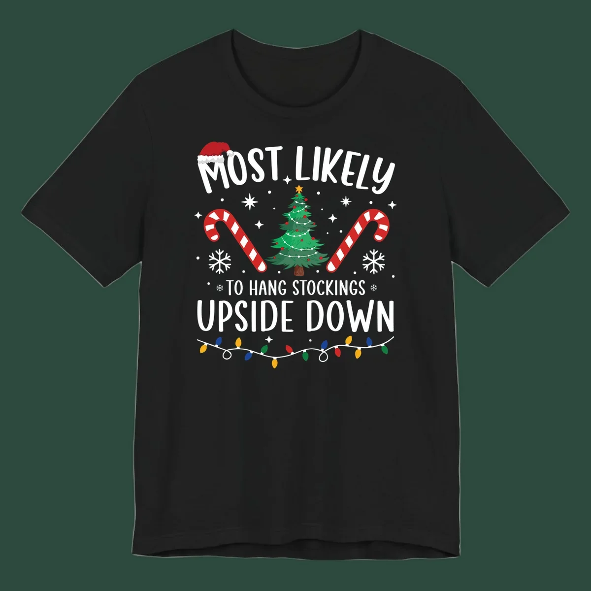 Most Likely To Hang Stockings Upside Down Christmas graphic with tree, candy canes, and Santa hat.
