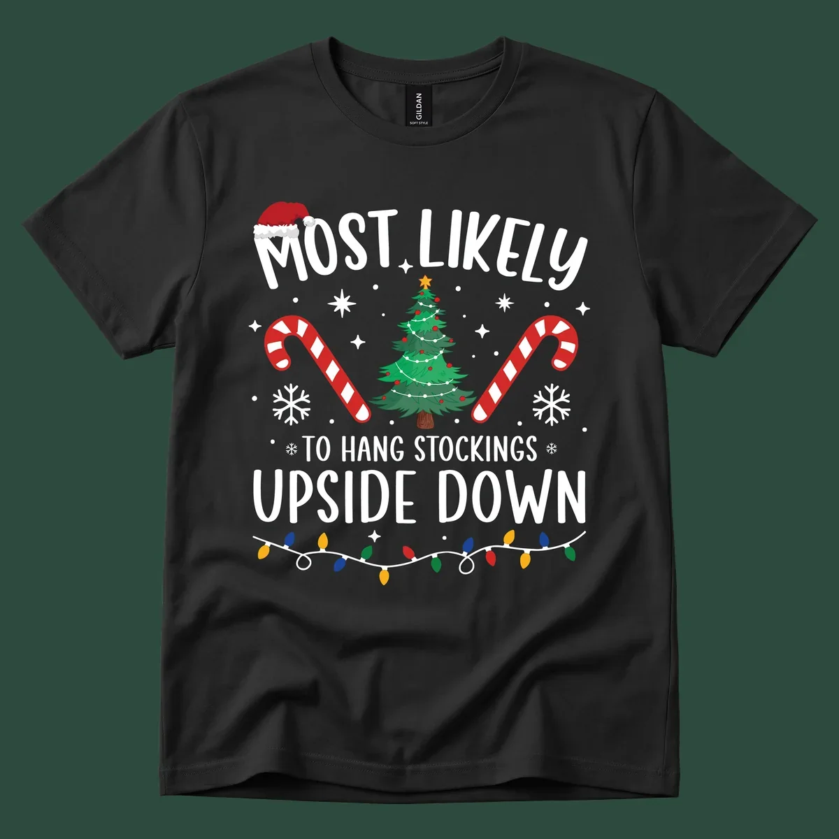Most Likely To Hang Stockings Upside Down Christmas graphic with tree, candy canes, and Santa hat.