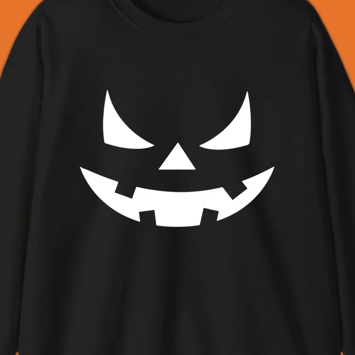 Spooky jack-o-lantern face illustration with angled eyes and jagged smile, for Halloween.