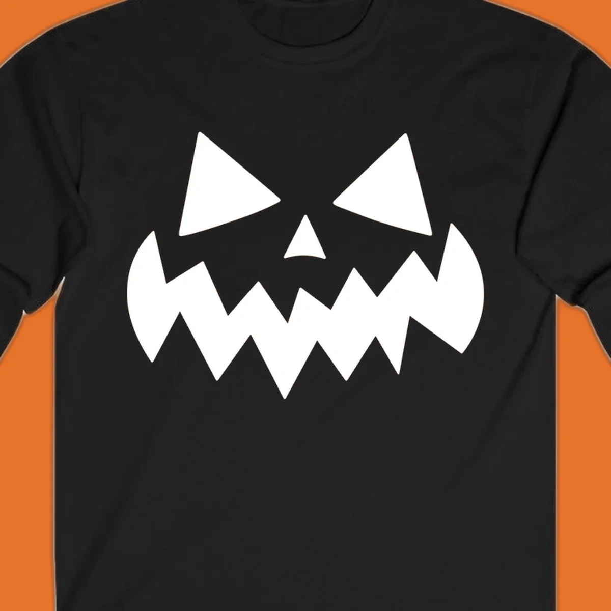 Spooky jack-o-lantern face with triangular eyes and a jagged mouth graphic.