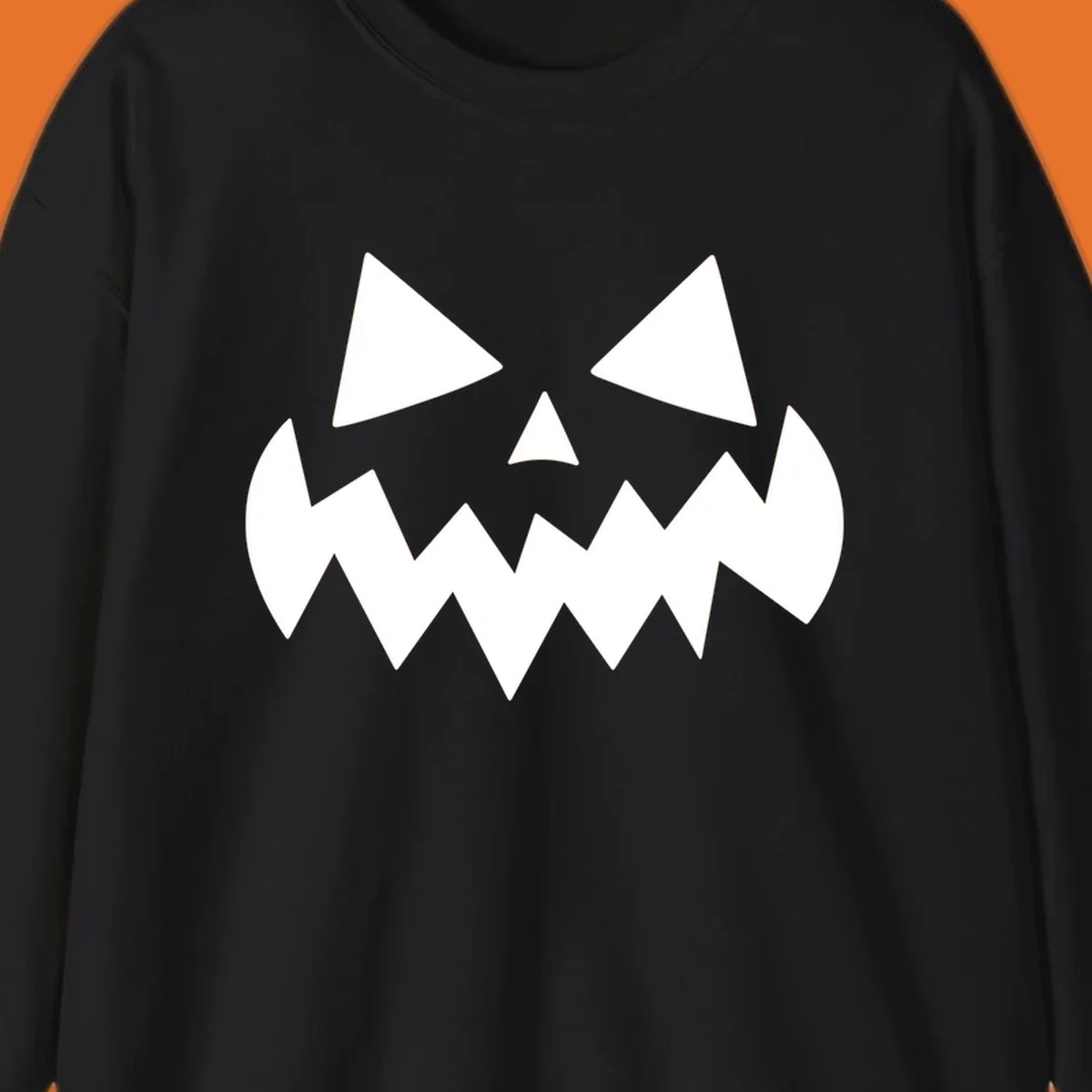 Spooky jack-o-lantern face with triangular eyes and a jagged mouth graphic.