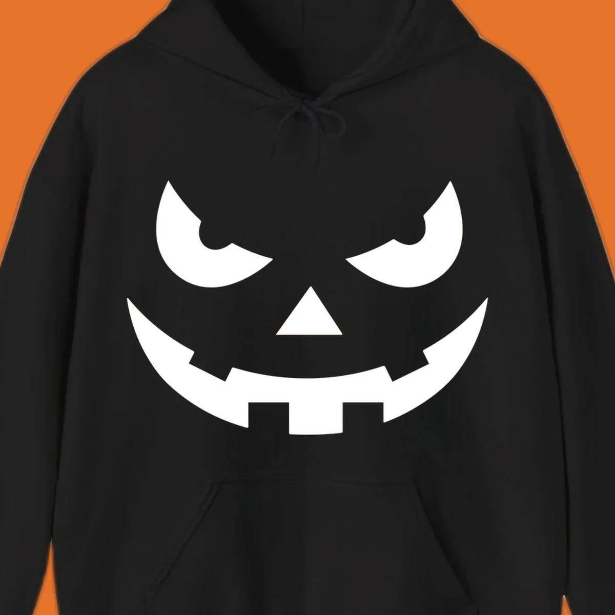 Spooky pumpkin face graphic with sharp eyes and a jagged grin.