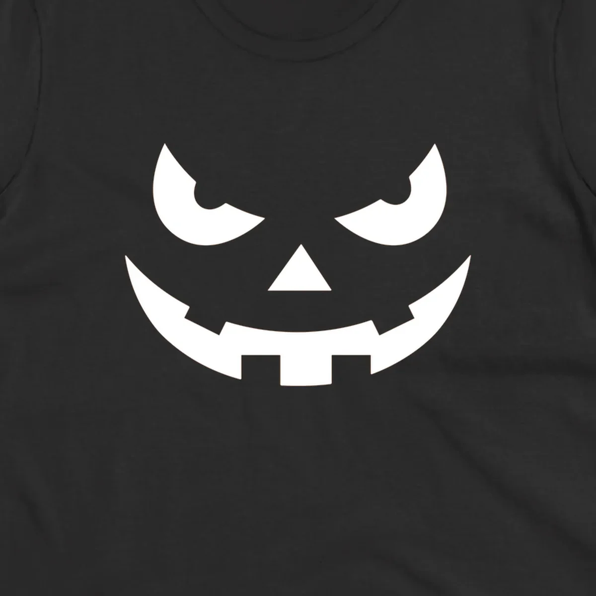 Spooky pumpkin face graphic with sharp eyes and a jagged grin.