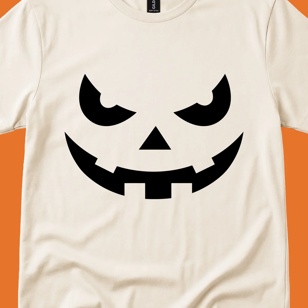 Spooky pumpkin face graphic with sharp eyes and a jagged grin.