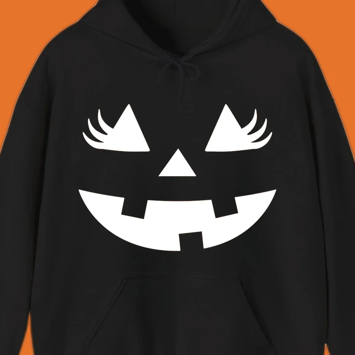 Jack o' lantern face with triangle eyes, nose, and jagged smile, featuring eyelashes.