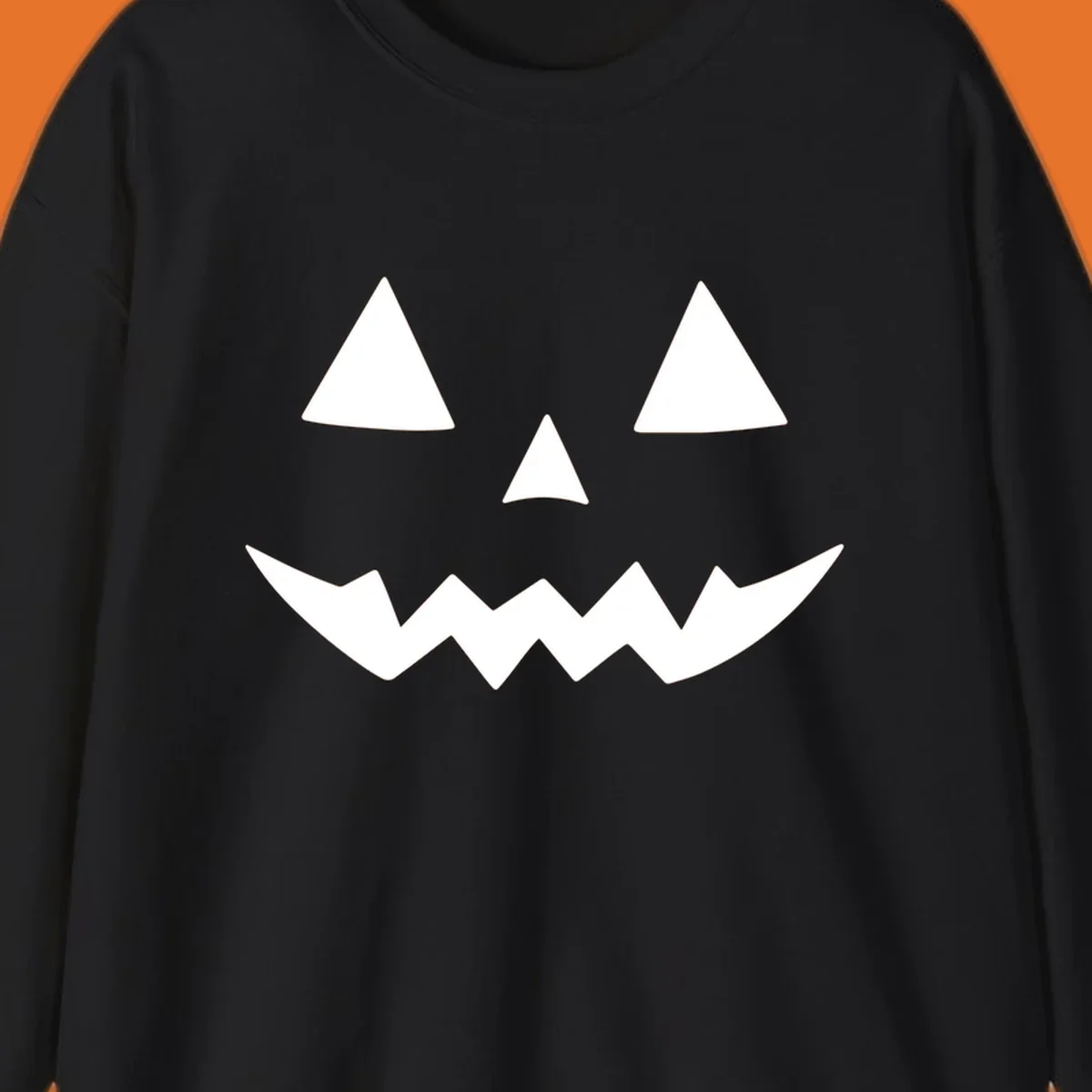 Classic jack-o-lantern face with triangle eyes and jagged mouth graphic.