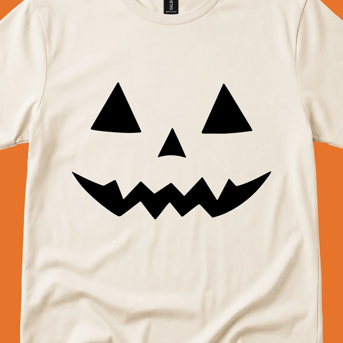 Classic jack-o-lantern face with triangle eyes and jagged mouth graphic.