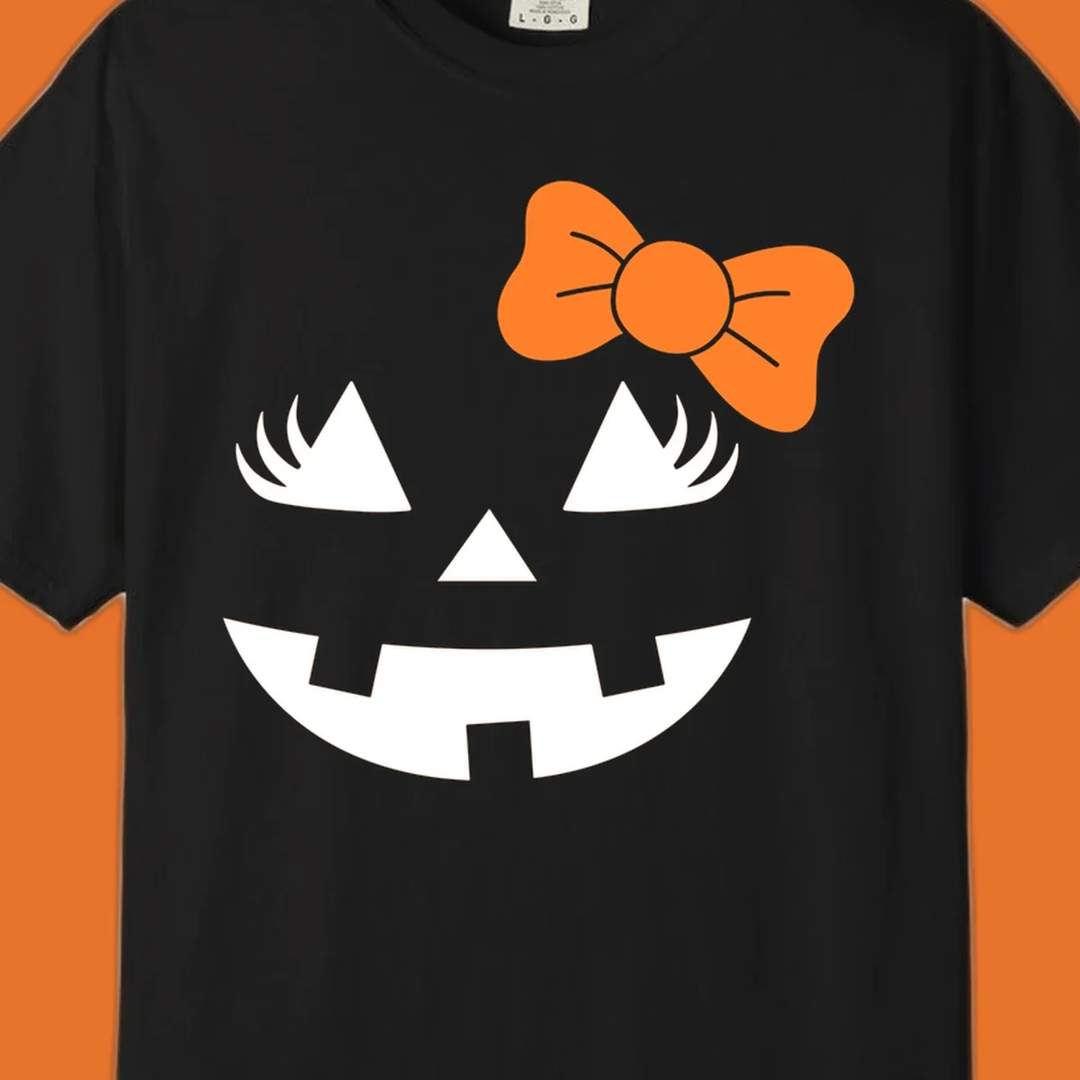 Cute halloween pumpkin face with an orange bow graphic